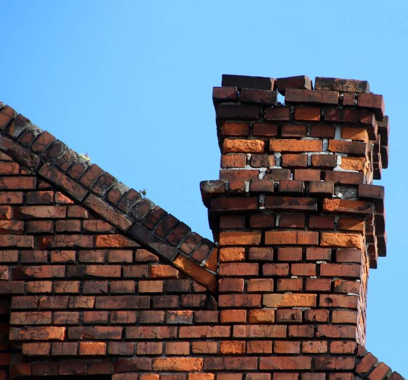 Damaged chimney on an Uxbridge home showing cracks and missing mortar